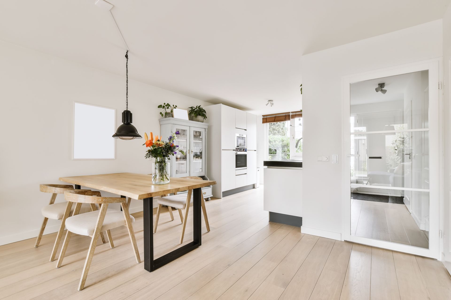 Home addition remodeling with drywall installation and tools set up in bright unfinished room.