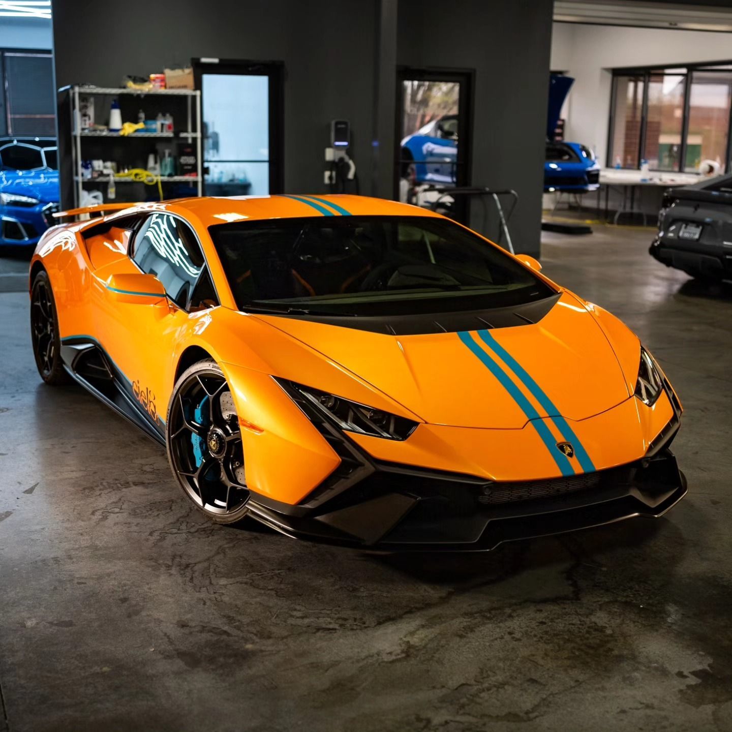 Orange Lamborghini with ppf parked inside a professional auto detailing studio.