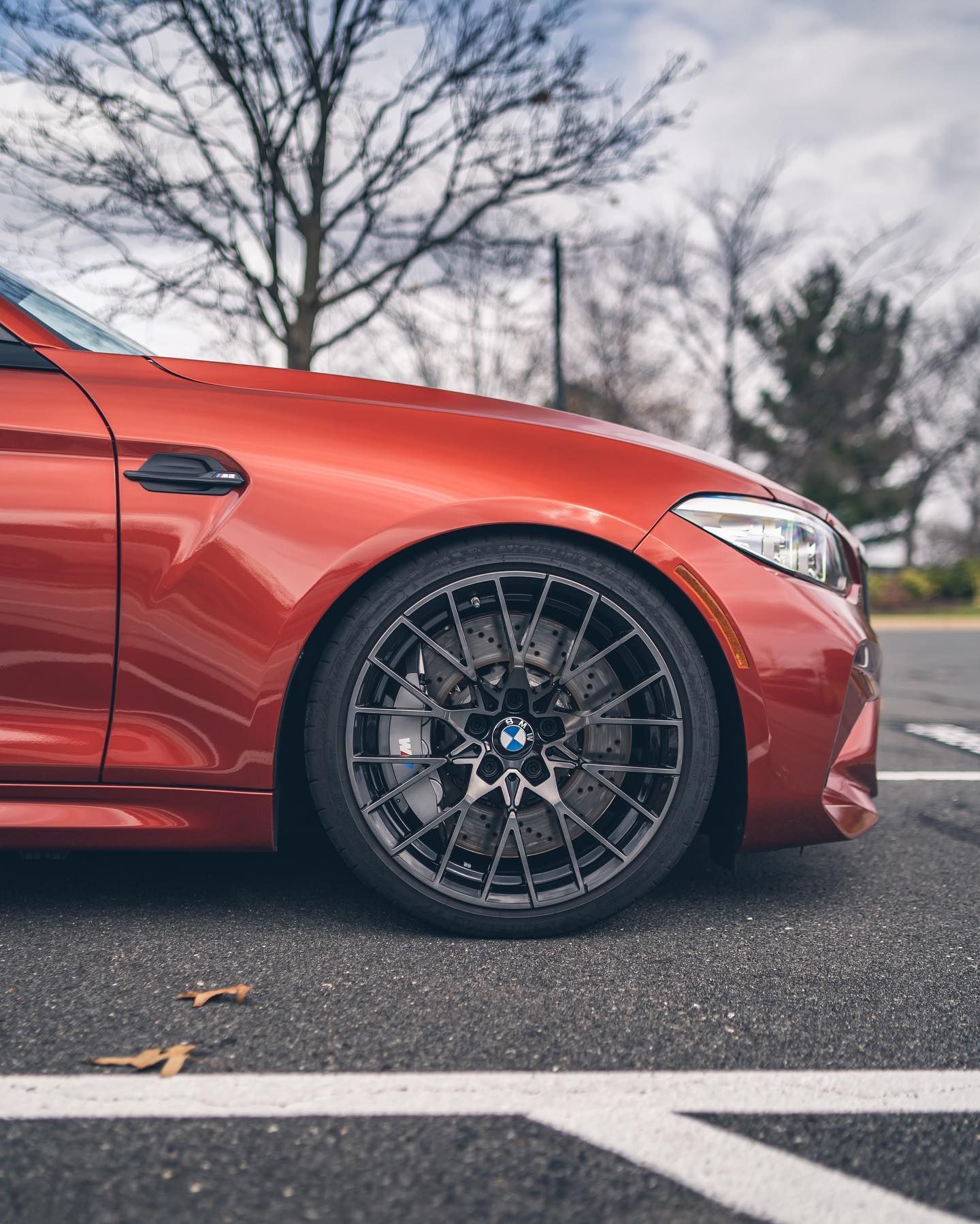Red BMW with black wheels and color change PPF for enhanced protection.