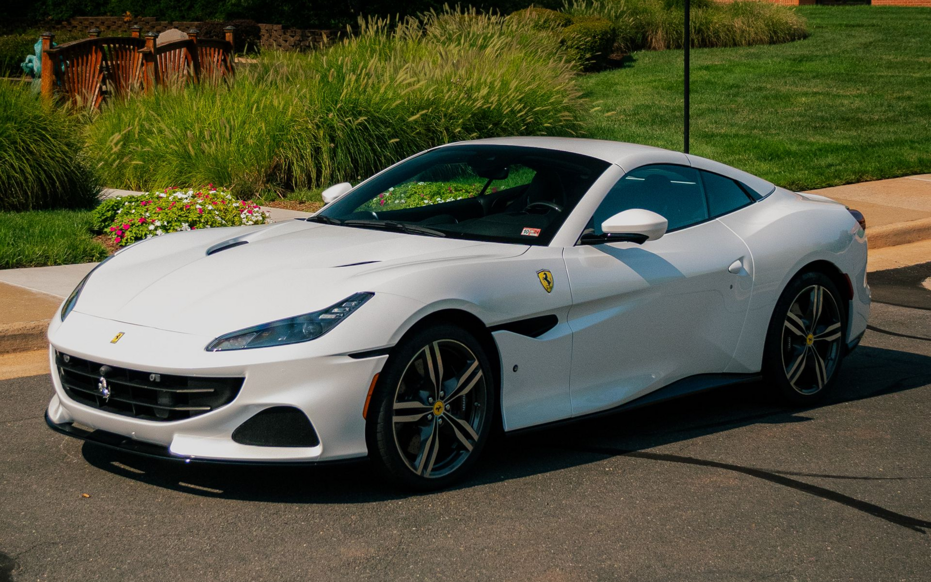 ceramic coated white ferrari sports car parked on the road