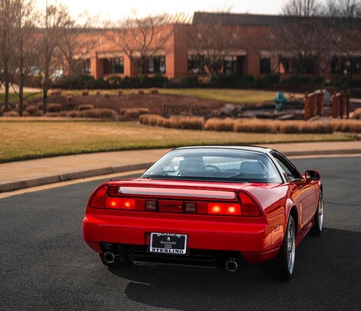 A red sports car is parked on the side of the road