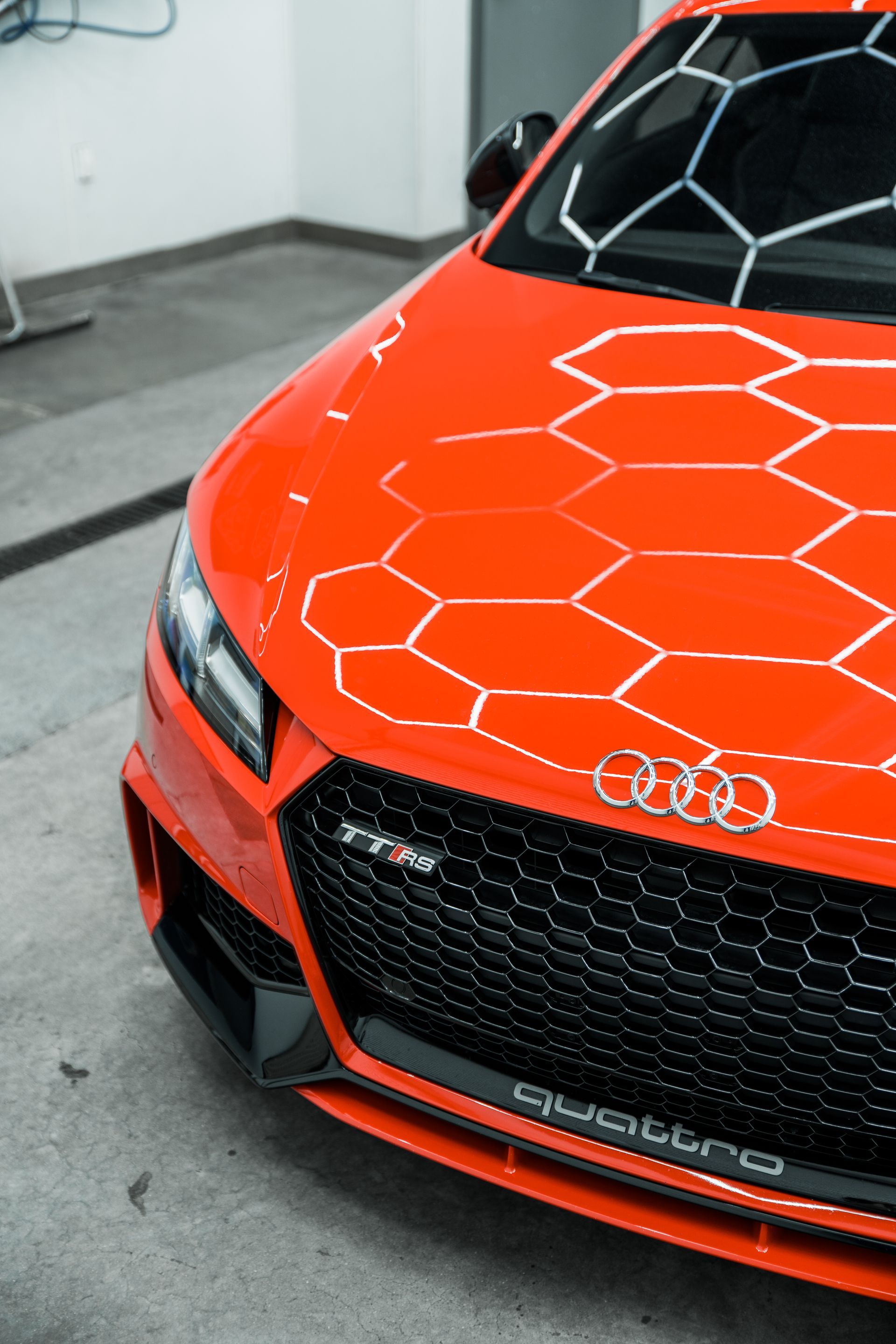 A close up of the front of a red audi car