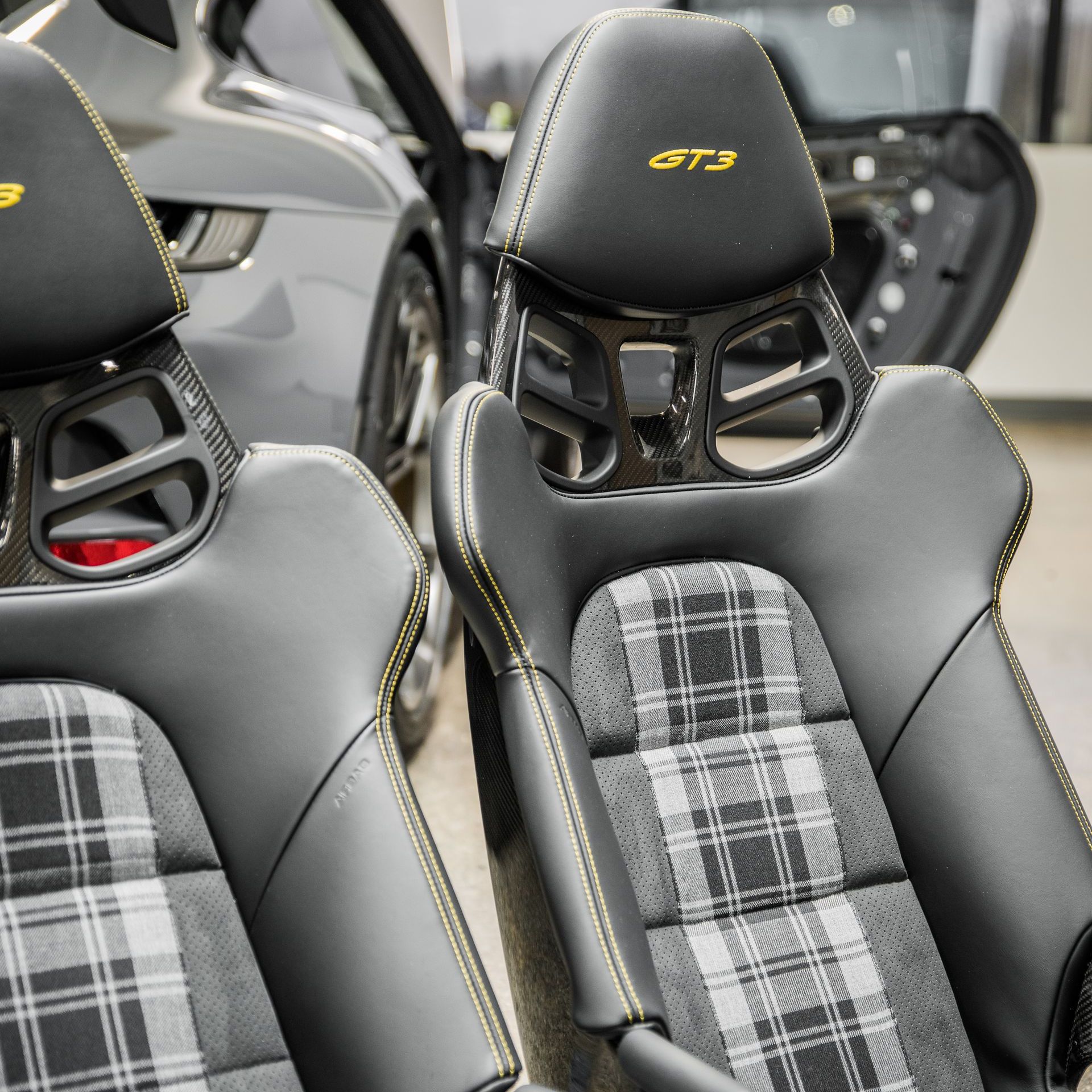 A pair of gt3 seats in front of a car