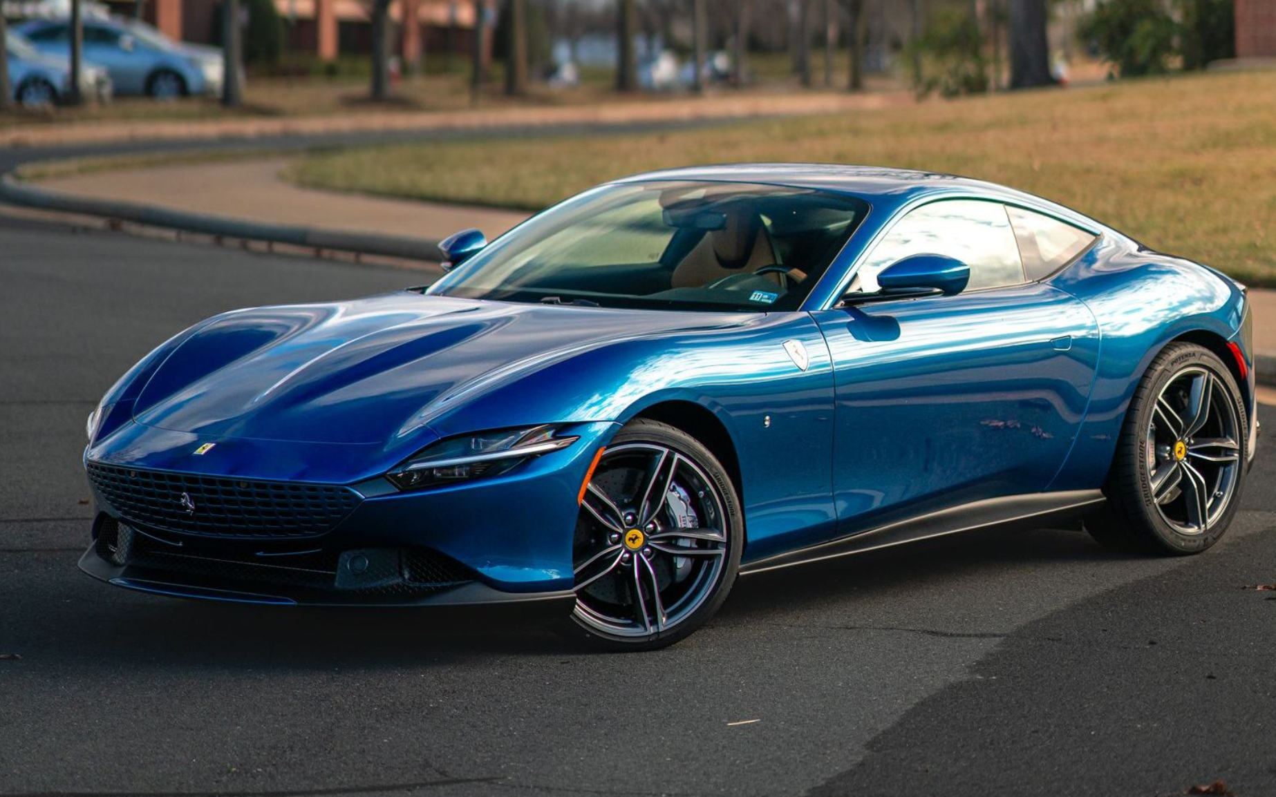 blue ferrari car with ppf parked on the road