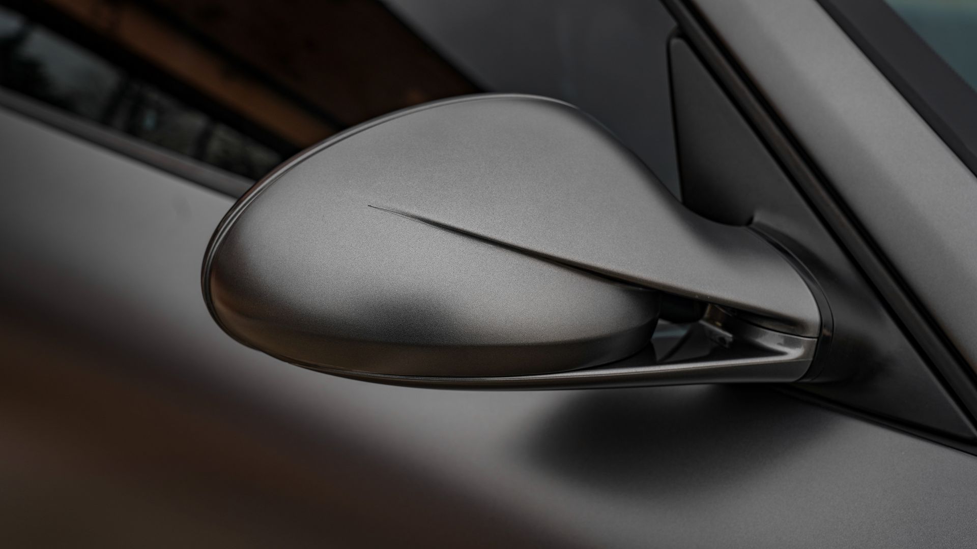 A close up of a side view mirror on a car.