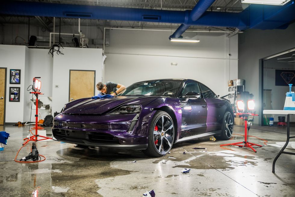 A purple sports car is parked in a garage.