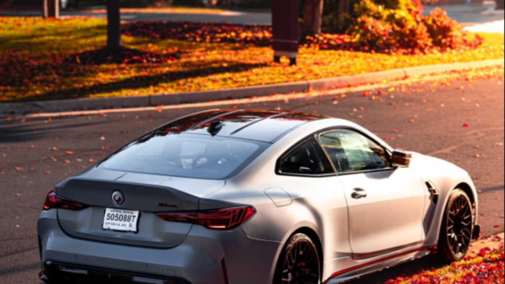 A white sports car is parked on the side of the road.