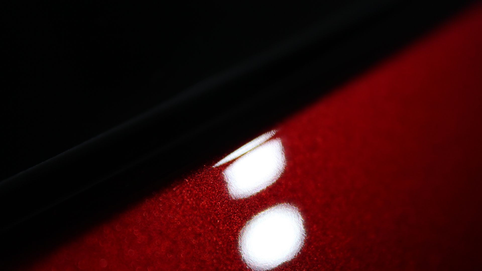 A close up of a red car with white dots on it.