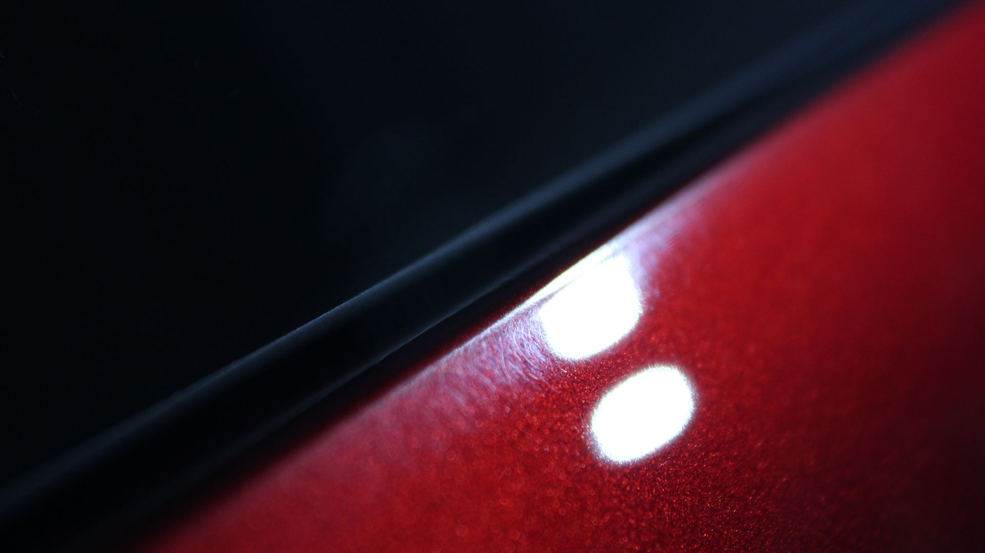 A close up of a red car with two white dots on it