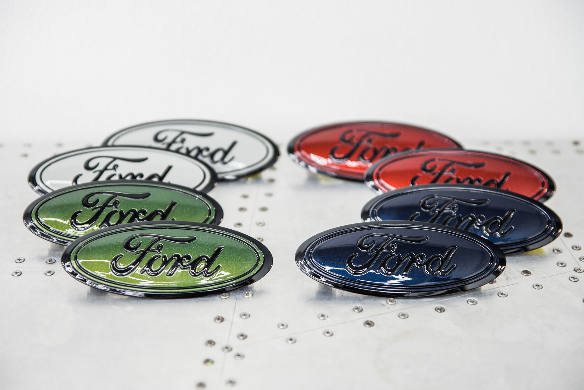 A group of ford emblems are sitting on a table.