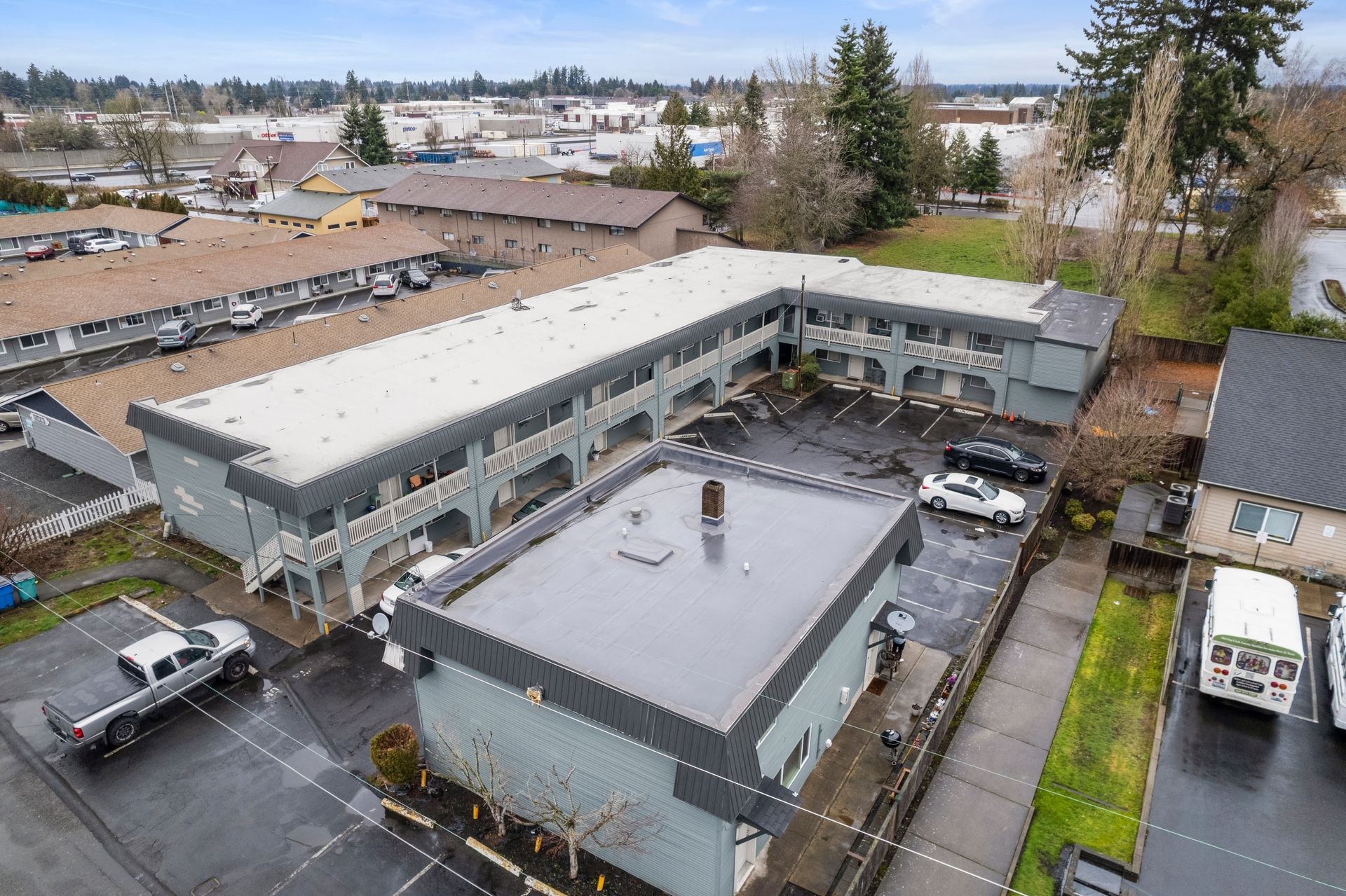 An aerial view of a large building with a parking lot in front of it.