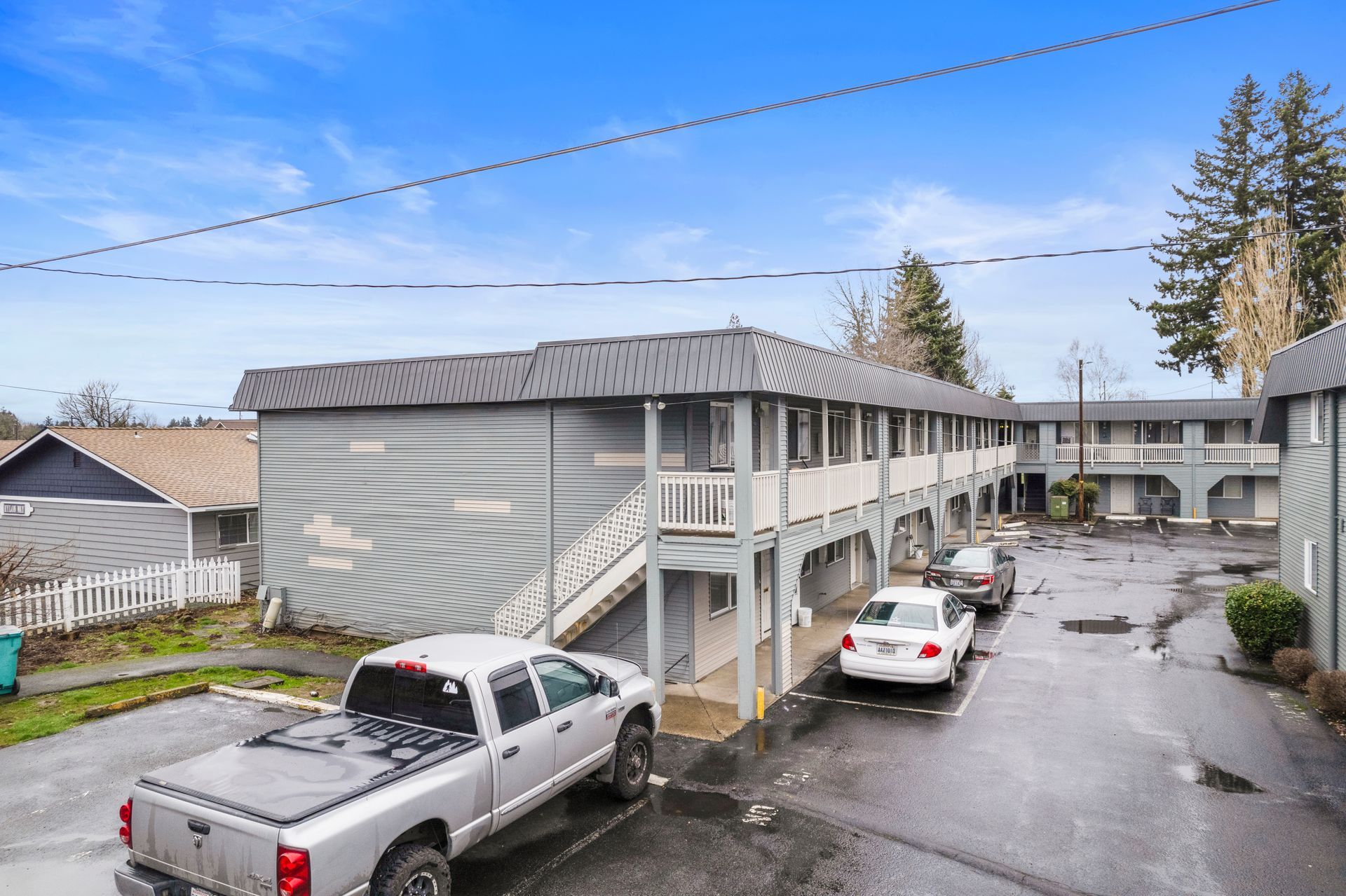 A white truck is parked in front of a building.