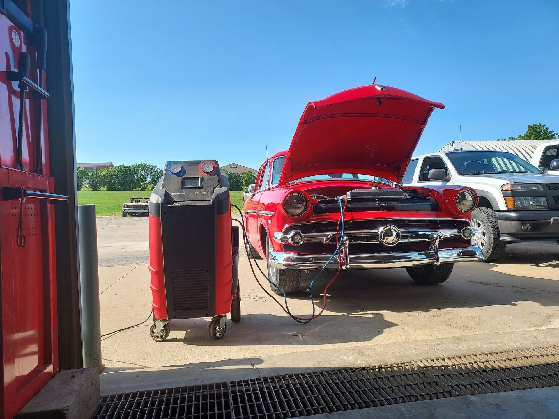 Red Classic Car with Open Hood Being Serviced | Kerp's Service Center
