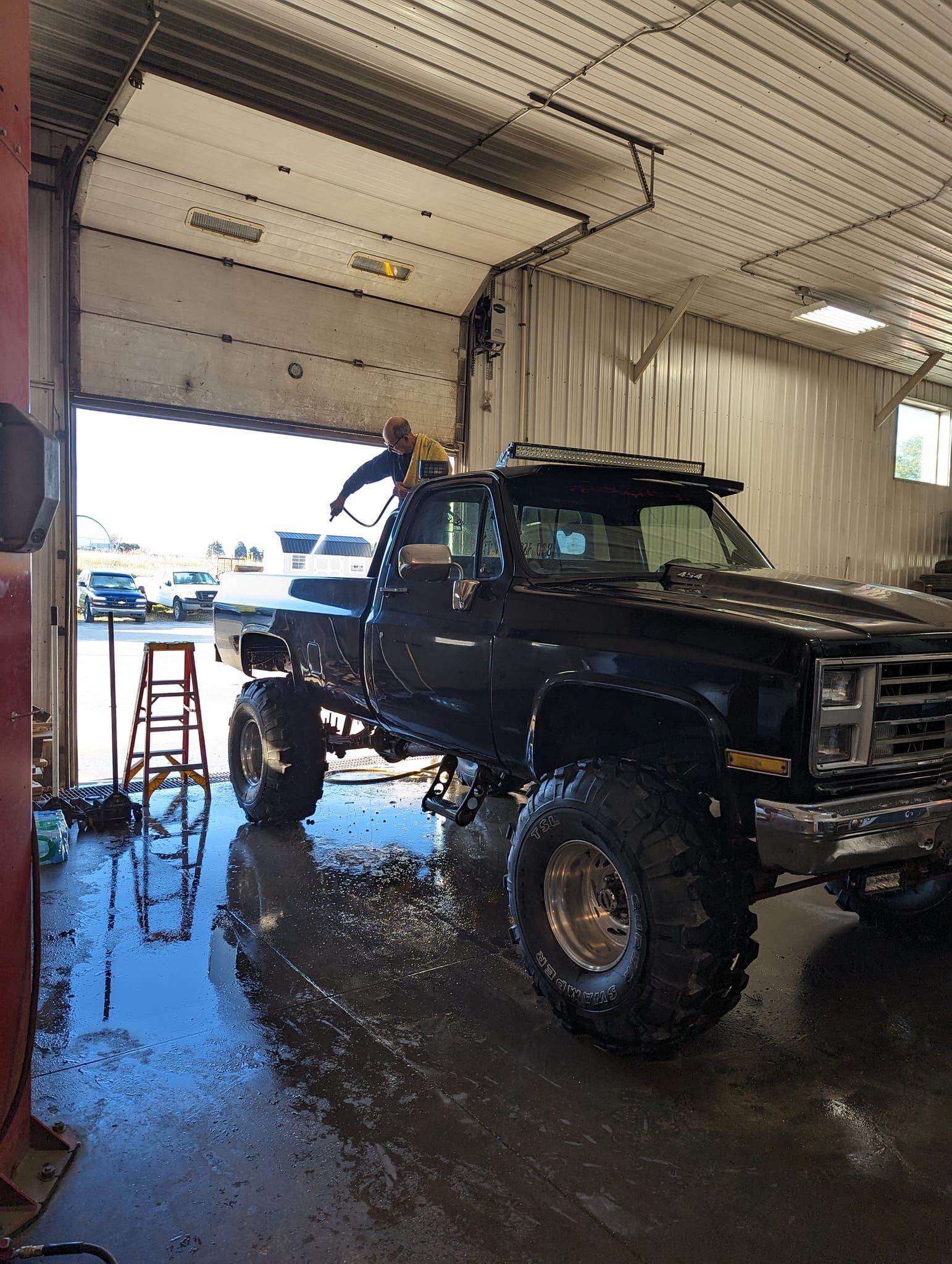 Black lifted pickup truck being washed inside a garage | Kerp's Service Center