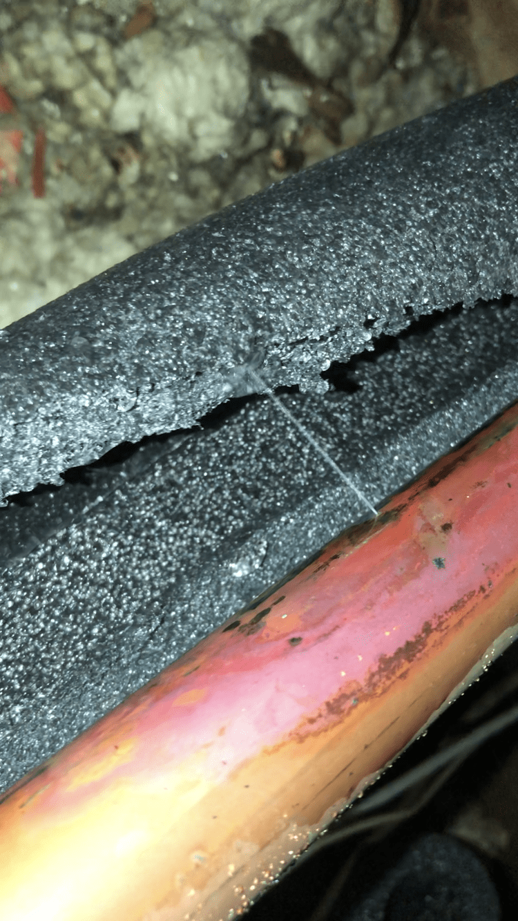 A close up of a broken pipe with a hole in it.