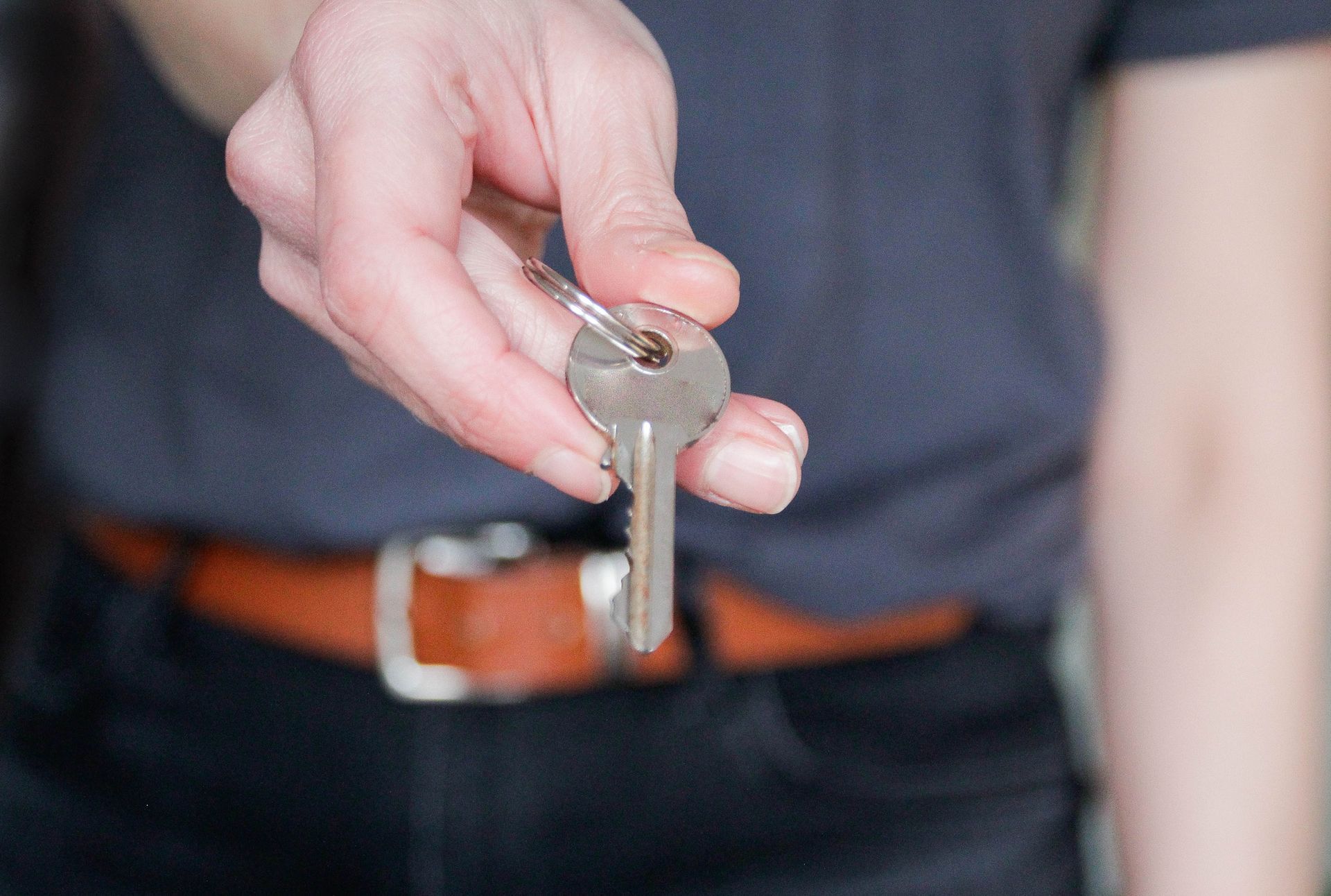 A person is holding a key in their hand.