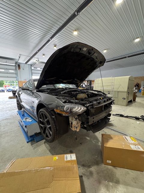 Car hood open inside B&G Auto Body repair shop for inspection