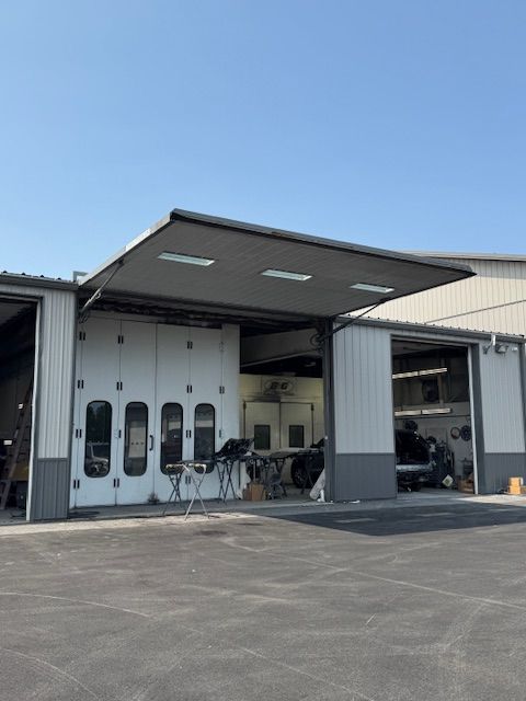 Exterior of B&G Auto Body building under clear blue sky