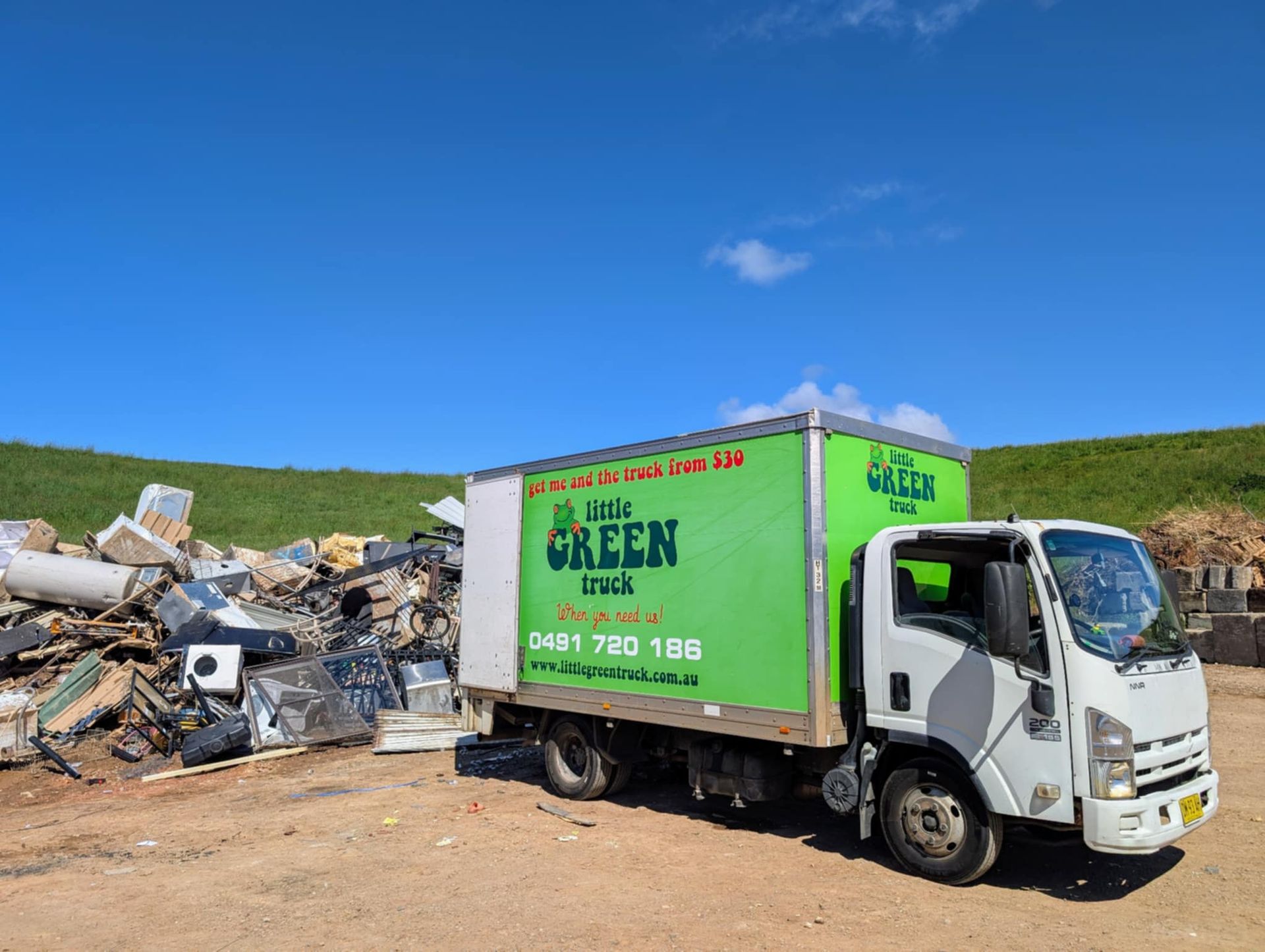 A Man is Standing in Front of a Green Little Green Truck — Little Green Truck Port Macquarie in Port Macquarie, NSW