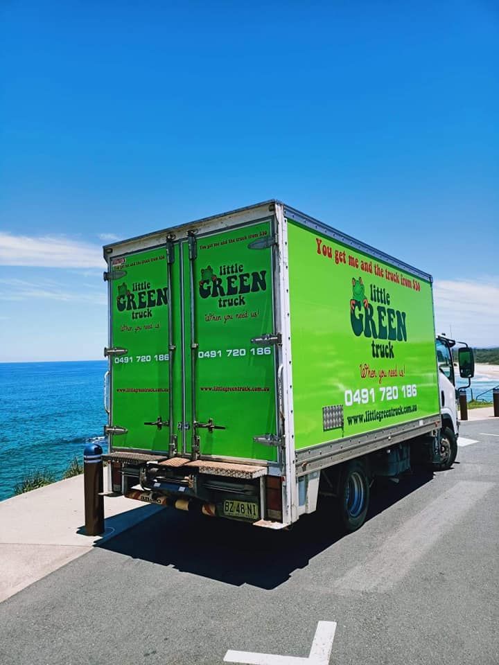 A Green Moving Truck is Parked on the Side of the Road — Little Green Truck Port Macquarie in Port Macquarie, NSW
