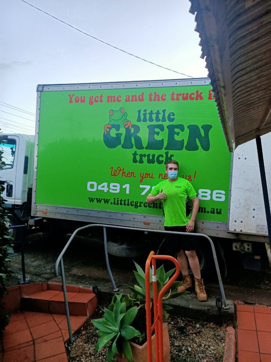 A Man is Standing in Front of a Green Little Green Truck — Little Green Truck Port Macquarie in Crescent Head, NSW