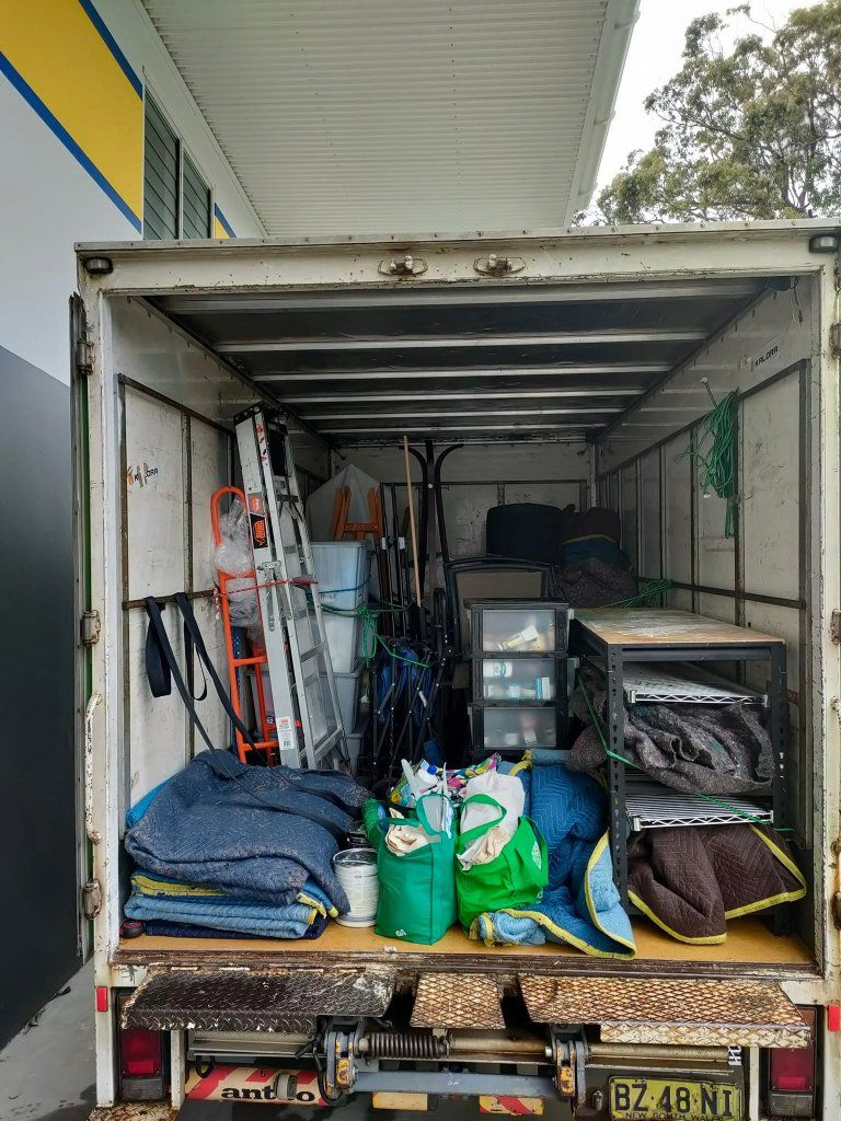 The Back of a Moving Truck is Filled With Lots of Moving Supplies — Little Green Truck Port Macquarie in Lake Cathie, NSW