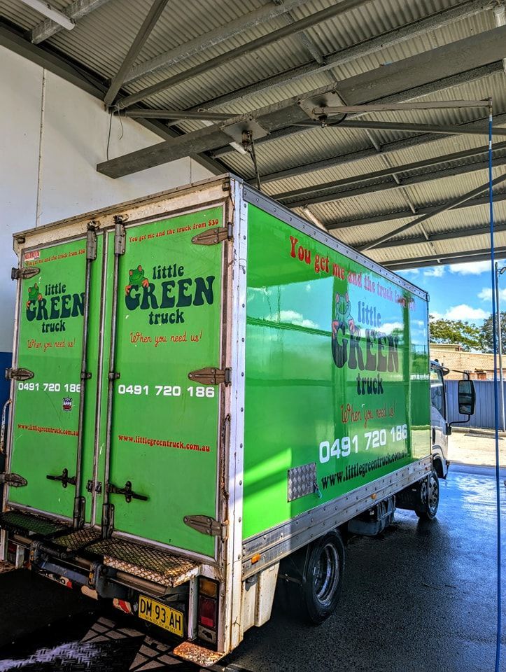 A Green Little Green Truck is Parked in a Garage — Little Green Truck Port Macquarie in Port Macquarie, NSW