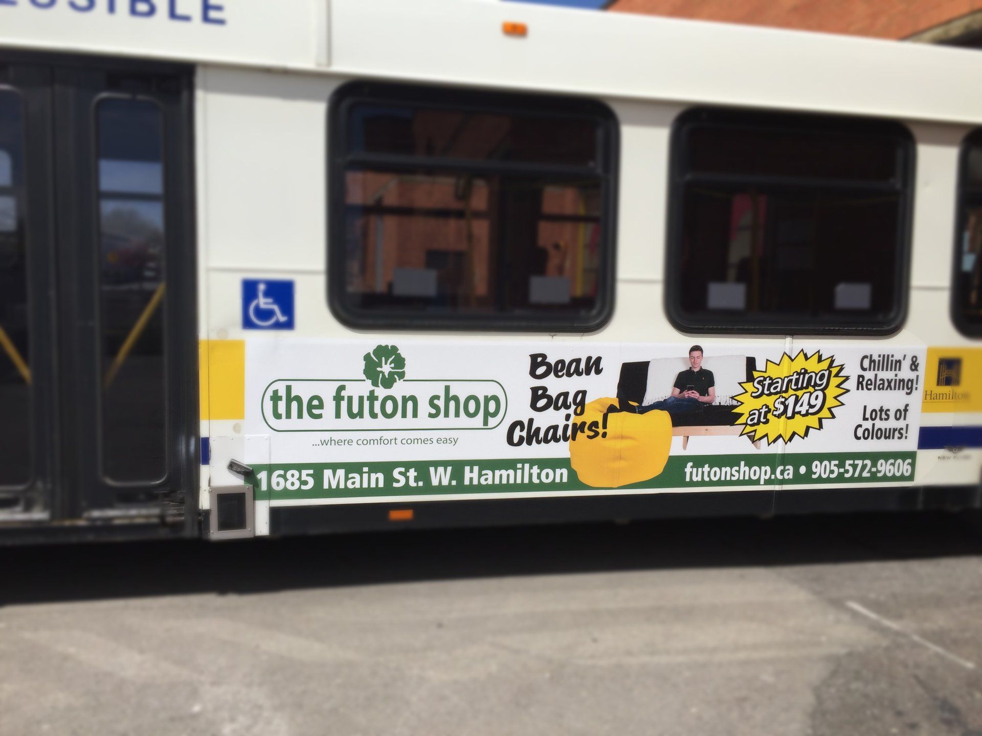 A bus with an advertisement for the futon shop