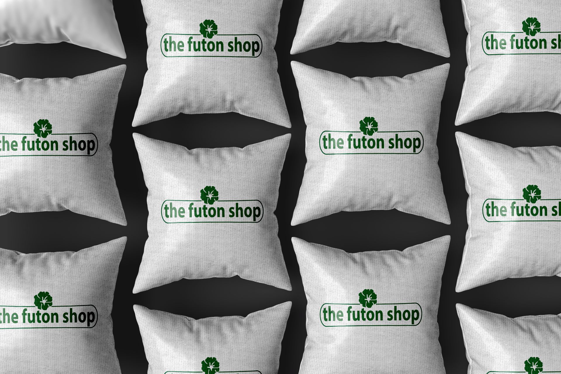 A row of white pillows with the futon shop written on them