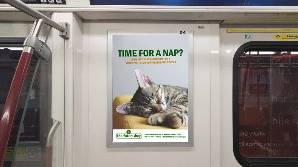 A cat is sleeping on a yellow pillow on a subway car.