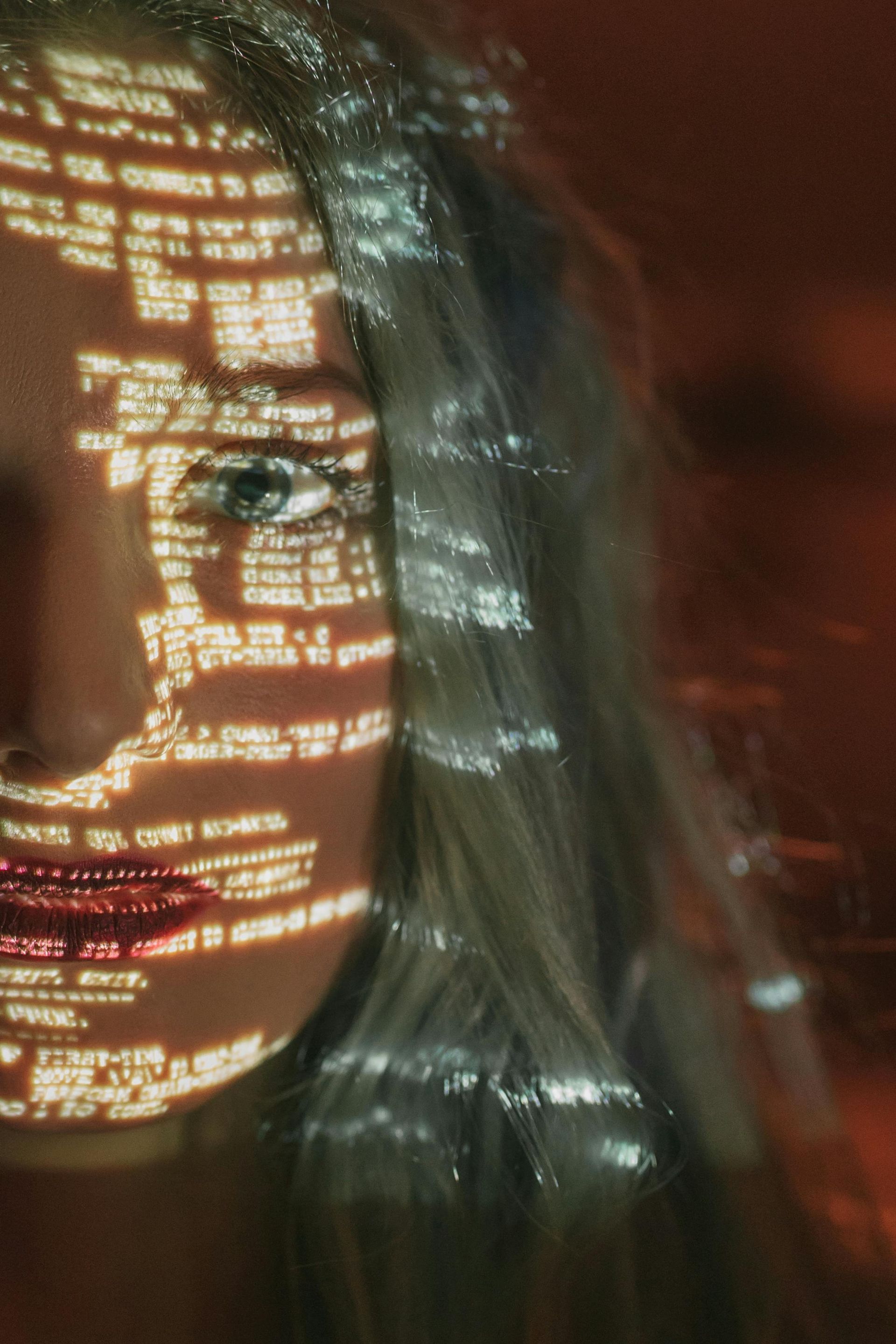 A close up of a woman 's face with lights projected on it.