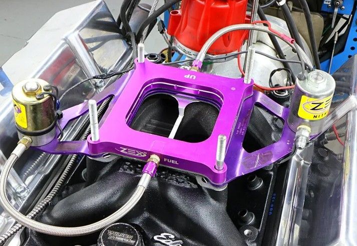 Purple fuel plate mounted on a black engine, with silver fuel lines and yellow components.