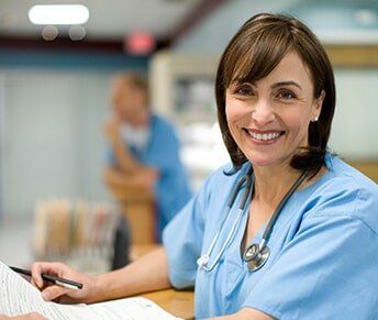 Female Doctor Holding Medical Records — Women's Clinic in Hialeah, FL