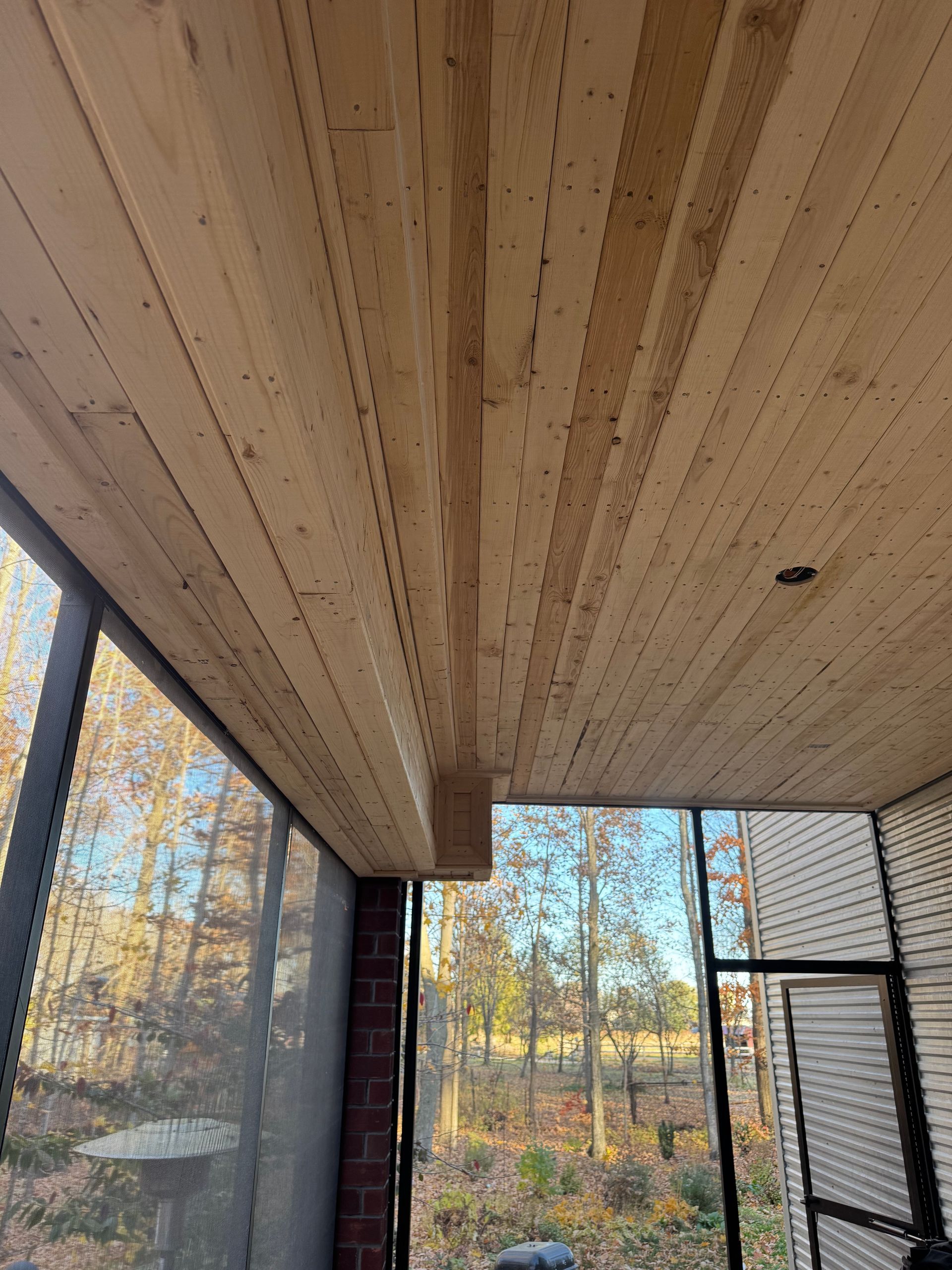 Woodworking tools and wood scraps scattered on a workbench, with a hammer and square prominent.
