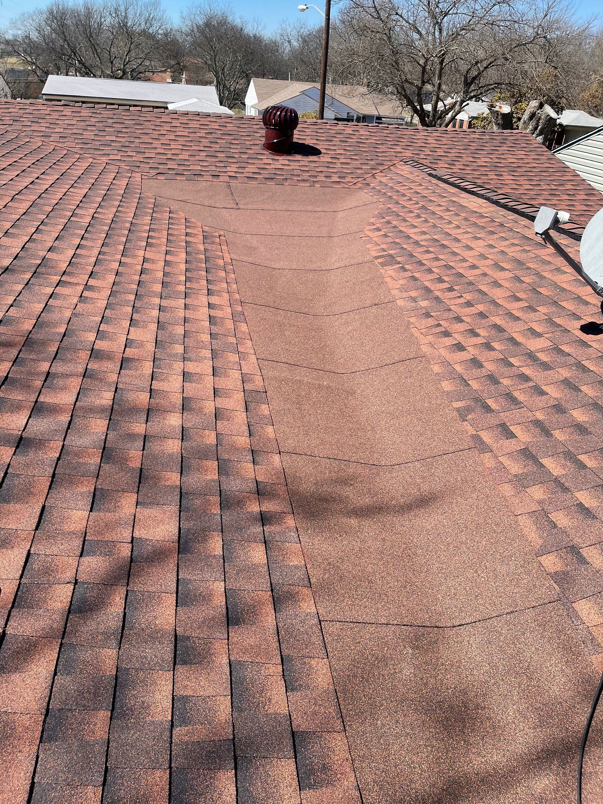 A close up of a roof with a chimney on top of it.