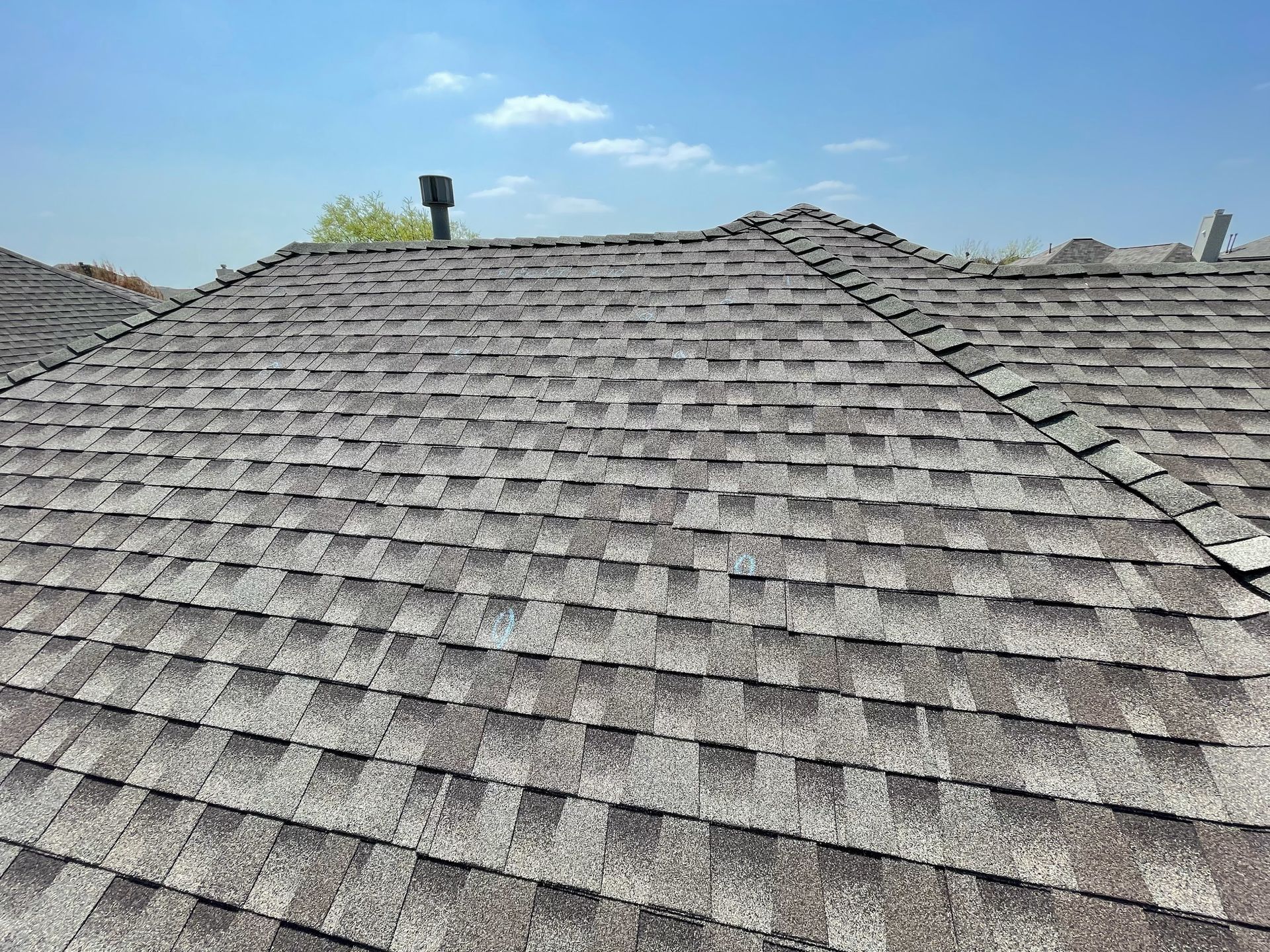 A close up of a roof with a blue sky in the background.