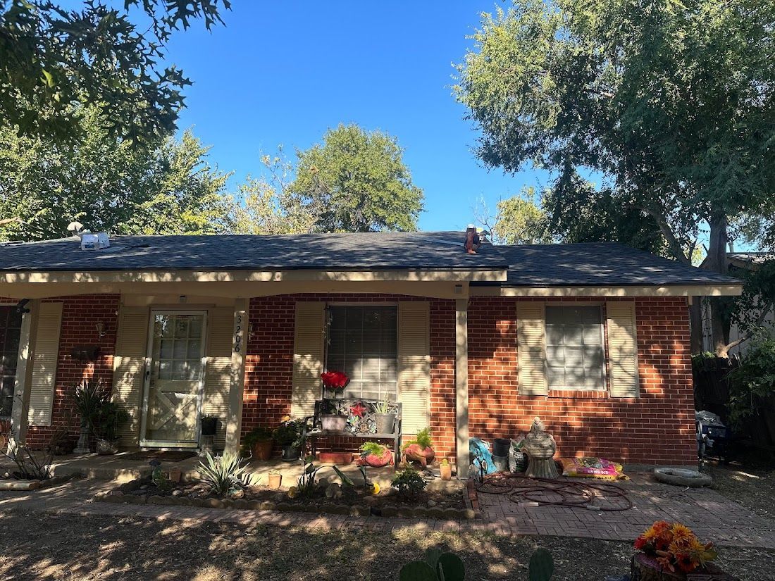 A brick house with a roof that is covered in shingles.
