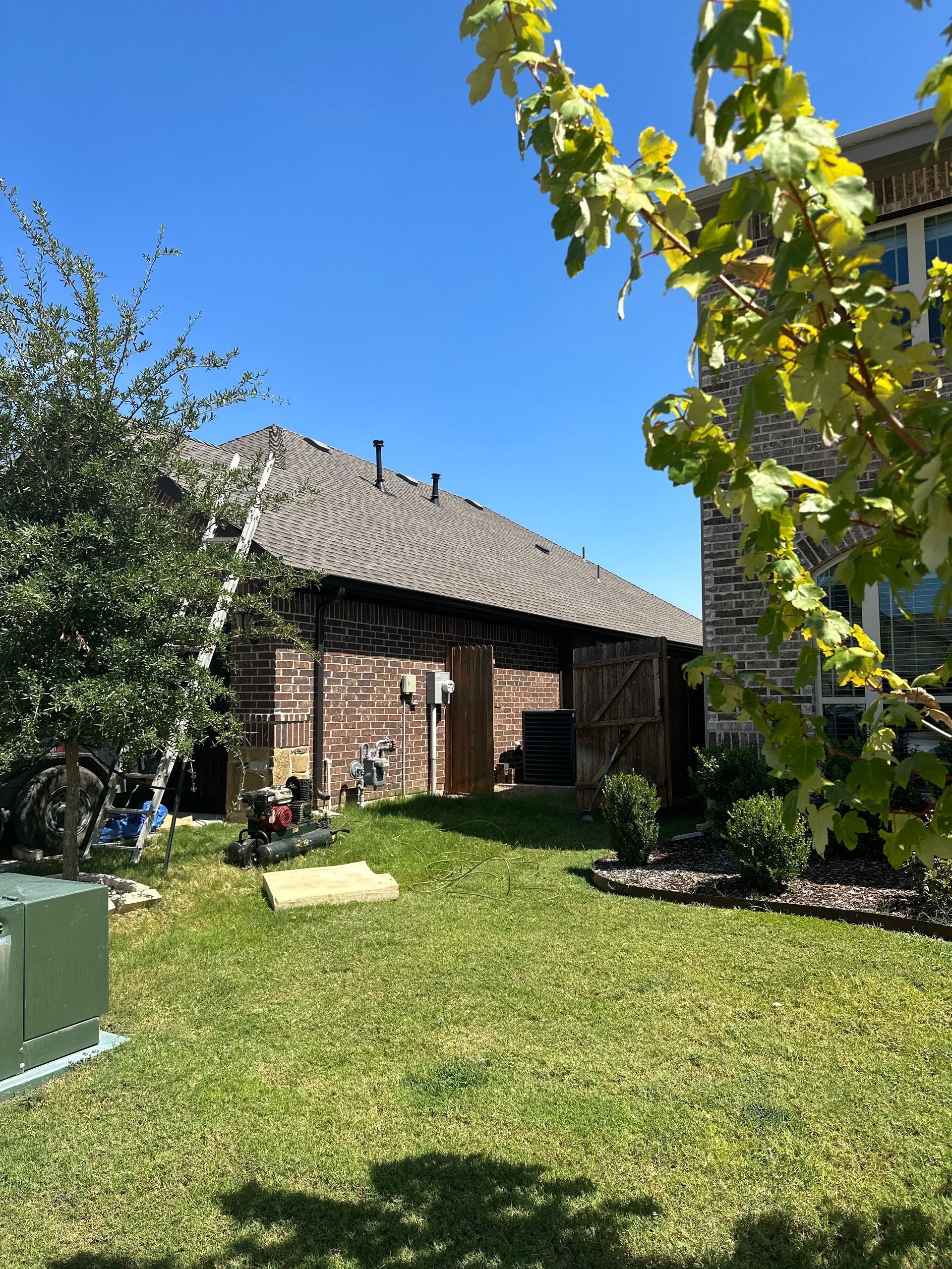 A brick house with a large lawn in front of it