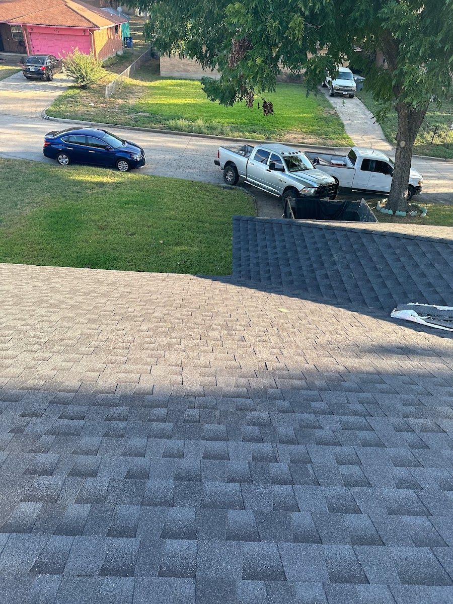 Two cars are parked on the roof of a house.