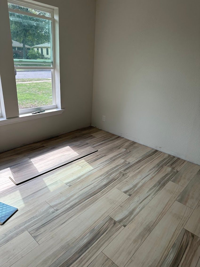 A room with hardwood floors and a window.