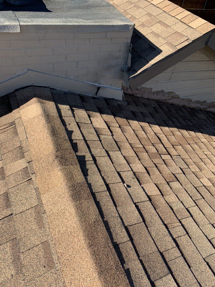 A close up of a roof with a chimney on top of it.