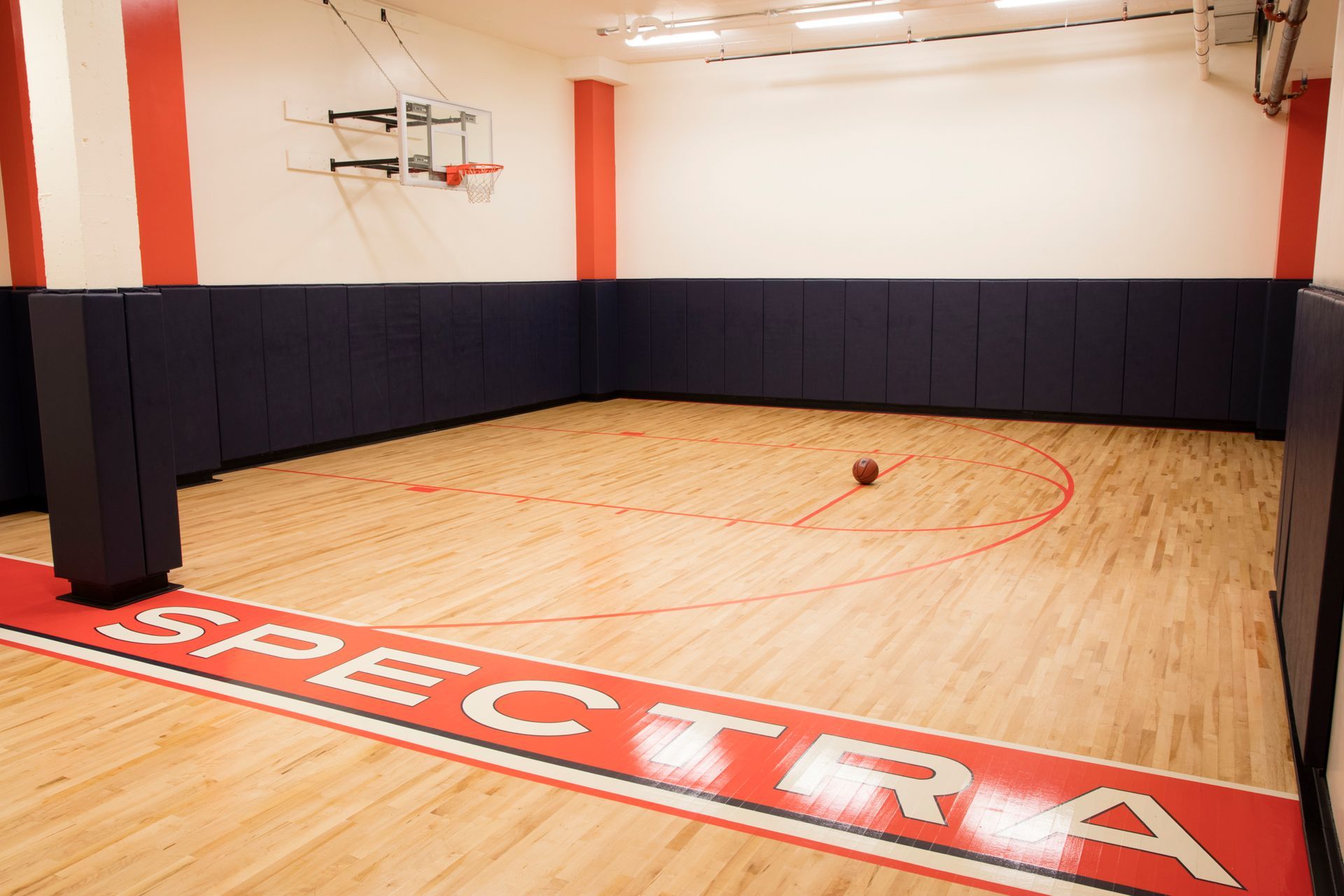 A basketball court with the word spectra on the floor