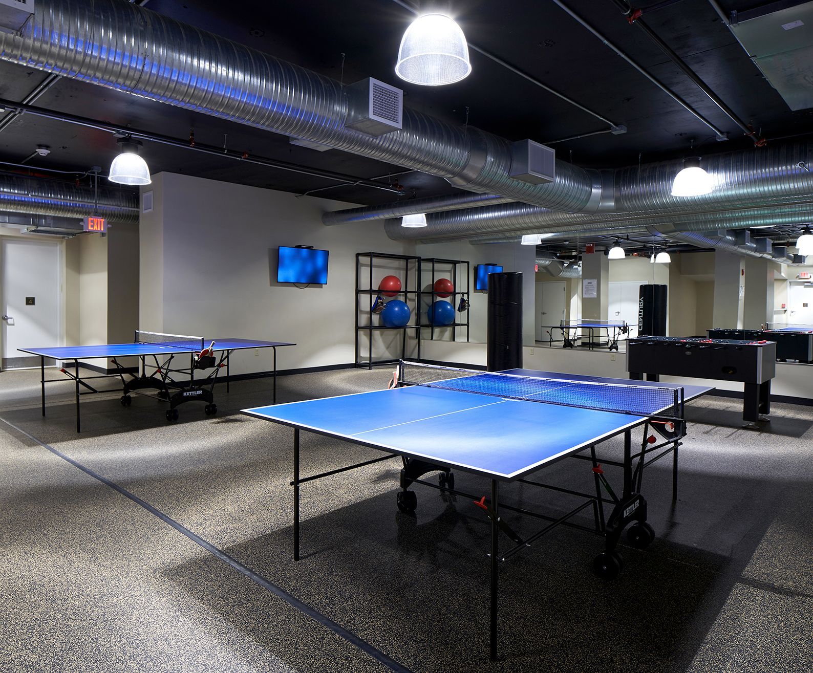 A room filled with ping pong tables and pool tables