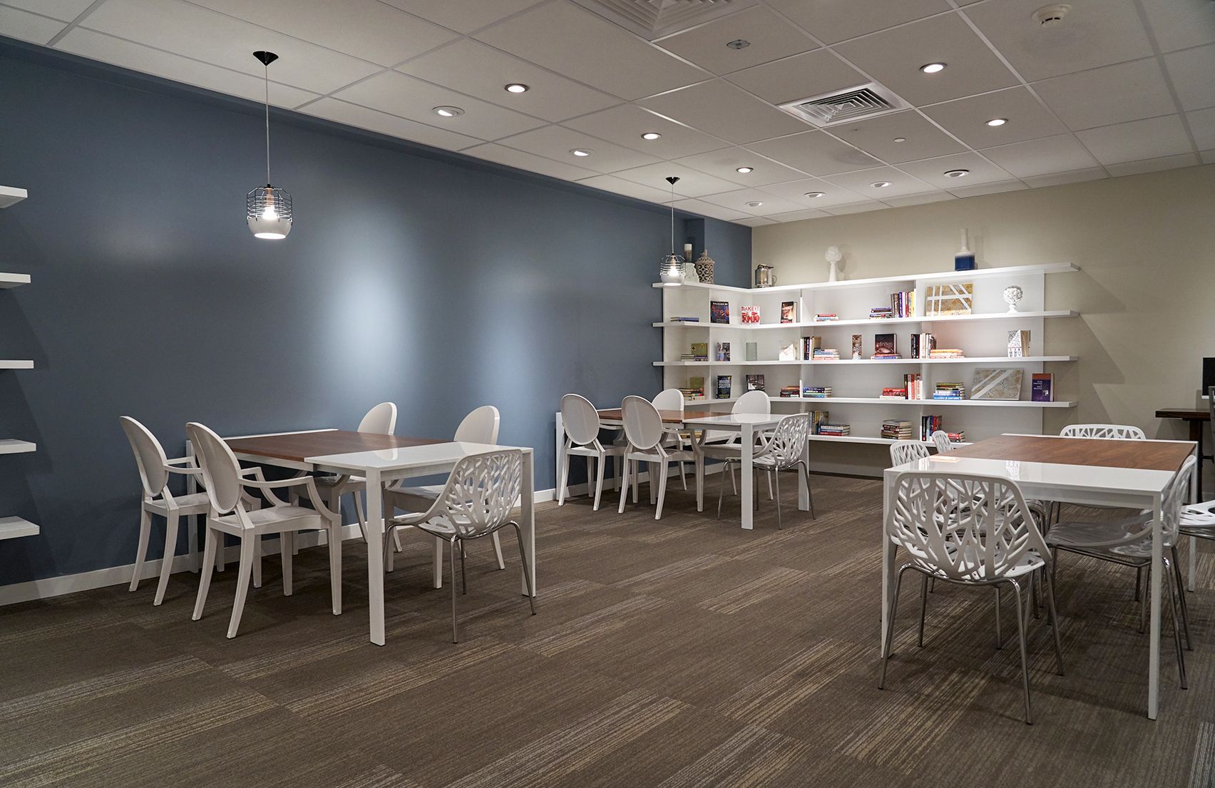 A large room with tables and chairs in it