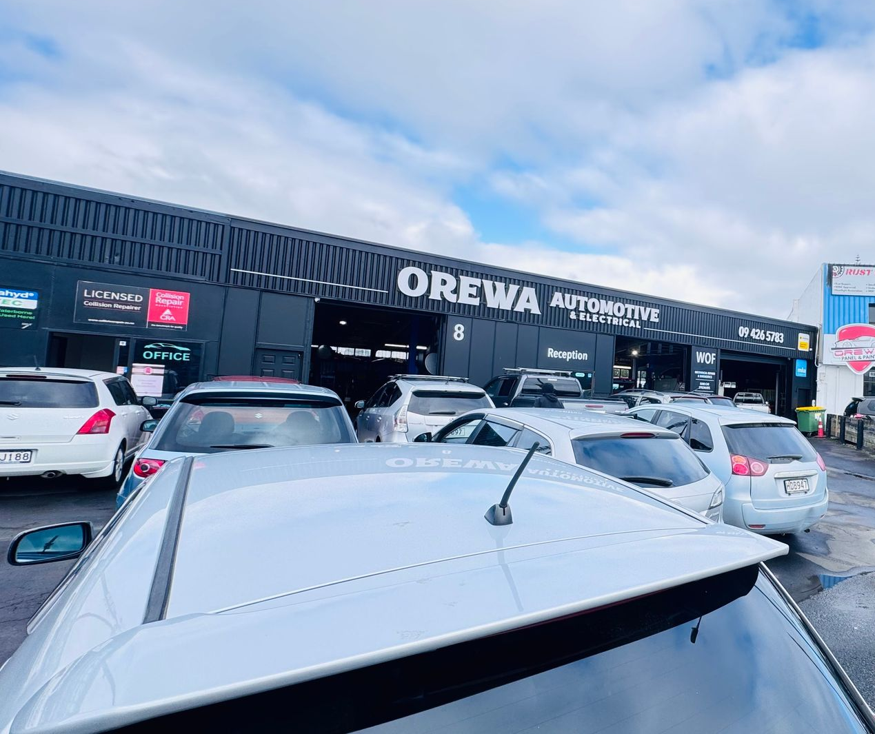 Orewa Automotive & Electrical workshop entrance with signage