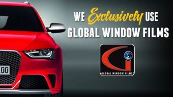 A red car is on a poster that says we exclusively use global window films