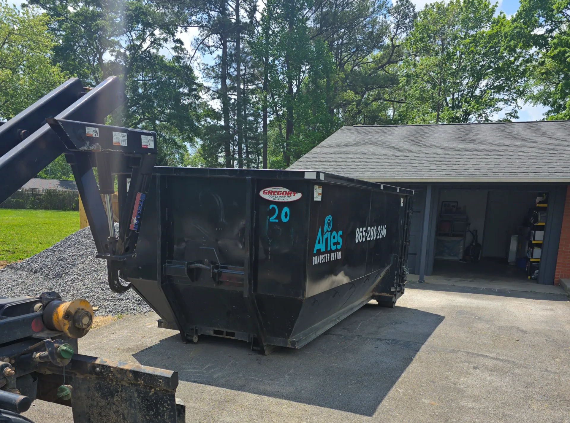 Black dumpster labeled 