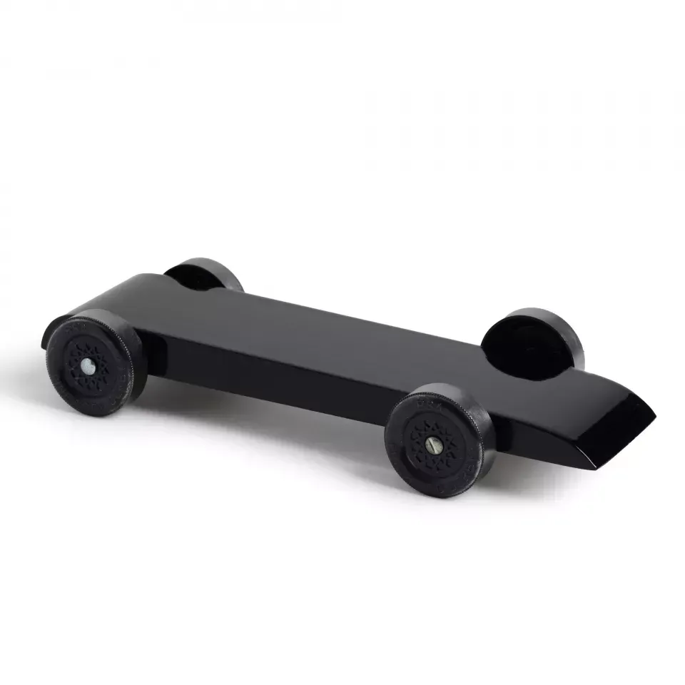 A black toy car with black wheels on a white background