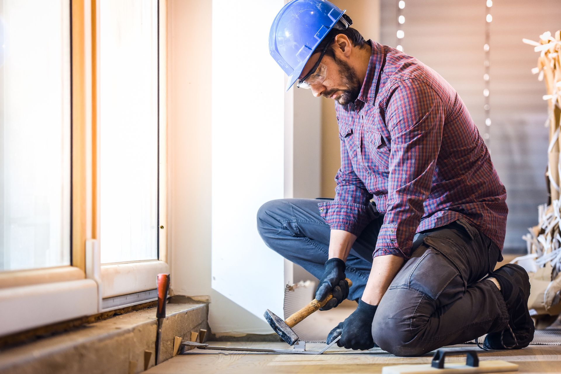 Worker repairing subfloor as part of a home foundation repair project.