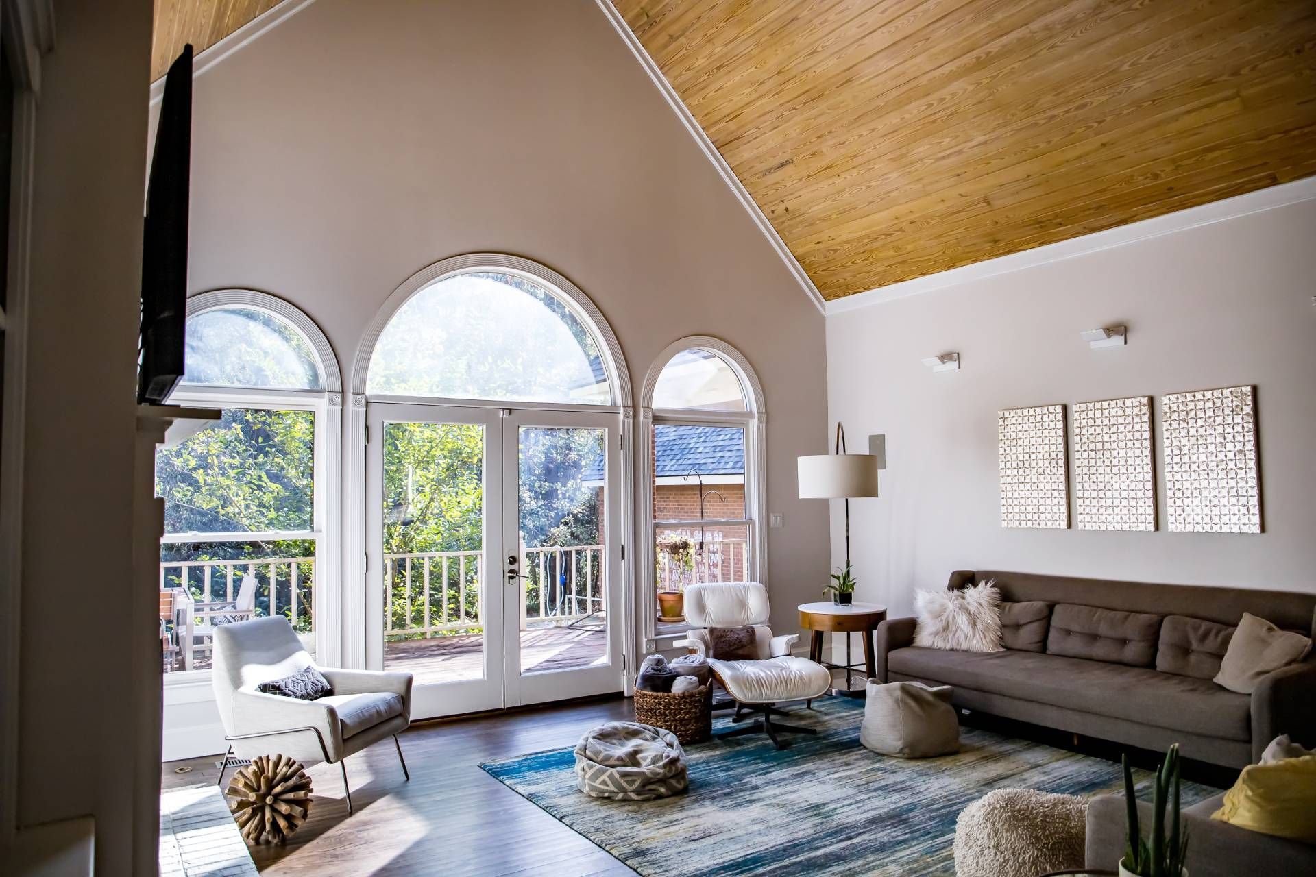 Beautiful arched windows and door inside a chic living room at Harmony Blinds & Shutters near San Di